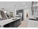 Spacious kitchen featuring an island, dark cabinetry, and stainless steel appliances at 8870 Backspin Ln, Champions Gate, FL 33896