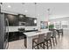 Eat-in kitchen with an island, dark cabinetry, and stainless steel appliances at 8870 Backspin Ln, Champions Gate, FL 33896