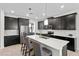 Modern kitchen with island, dark cabinets, and quartz countertops at 8870 Backspin Ln, Champions Gate, FL 33896