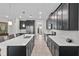 Modern kitchen with dark cabinetry, white countertops, and stainless steel appliances at 8870 Backspin Ln, Champions Gate, FL 33896