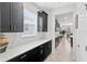Modern kitchen with dark cabinets and quartz countertops at 8870 Backspin Ln, Champions Gate, FL 33896