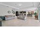 Open living room with gray sofas and views into the kitchen and dining area at 8870 Backspin Ln, Champions Gate, FL 33896