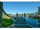 Wooden dock extending over a calm lake with rope railings at 4006 San Gallo Dr # 108, Kissimmee, FL 34741