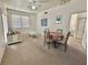 Combined living and dining area with light carpet and white furniture at 4006 San Gallo Dr # 108, Kissimmee, FL 34741