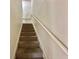 Carpeted staircase with white railings at 4006 San Gallo Dr # 108, Kissimmee, FL 34741