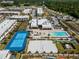 Aerial view of community pool, tennis court, and modern townhouses at 7537 Brooklyn Dr, Kissimmee, FL 34747