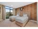 Spacious bedroom with two twin beds and a wood-paneled accent wall at 7537 Brooklyn Dr, Kissimmee, FL 34747