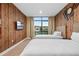 Bright bedroom with two twin beds, a wood-paneled wall, and large window at 7537 Brooklyn Dr, Kissimmee, FL 34747