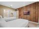 Bedroom with twin beds, wood-paneled wall, and access to bathroom at 7537 Brooklyn Dr, Kissimmee, FL 34747