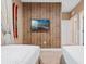 Twin bedroom with wood-paneled accent wall, TV, and ski decor at 7537 Brooklyn Dr, Kissimmee, FL 34747