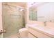 Modern bathroom features a glass-enclosed shower, vanity with sink, and white toilet at 10001 Newington Dr, Orlando, FL 32836