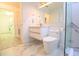 Modern bathroom features a floating vanity, decorative mirror, and tiled floor at 10001 Newington Dr, Orlando, FL 32836