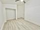 Bright bedroom with laminate flooring and an open closet with hanging bar at 10001 Newington Dr, Orlando, FL 32836