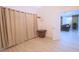 Bedroom with light walls, beige curtains, and access to another room at 10001 Newington Dr, Orlando, FL 32836