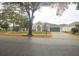 Charming single-story home with well-manicured lawn, mature trees, and attached two-car garage at 10001 Newington Dr, Orlando, FL 32836