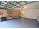 Organized garage space with shelving, epoxy flooring, and washer/dryer hookups at 10001 Newington Dr, Orlando, FL 32836