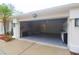 Attached garage with epoxy flooring, storage shelves, and access to laundry appliances at 10001 Newington Dr, Orlando, FL 32836