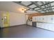Well-lit garage featuring ample storage cabinets and an access door to the interior at 10001 Newington Dr, Orlando, FL 32836