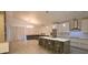 Open kitchen with island, stainless appliances, and adjacent living area with large sectional at 10001 Newington Dr, Orlando, FL 32836
