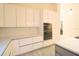 Modern kitchen with white cabinetry, stainless steel appliances, and quartz countertops at 10001 Newington Dr, Orlando, FL 32836