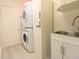Functional laundry room with stacked washer and dryer and convenient utility sink at 10001 Newington Dr, Orlando, FL 32836