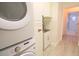 Laundry area with washer, dryer, sink, and access to tiled bathroom at 10001 Newington Dr, Orlando, FL 32836