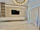 Bright living room with modern lighting, TV, built in cabinets and neutral colors at 10001 Newington Dr, Orlando, FL 32836