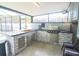 Modern outdoor kitchen featuring a grill, sink, and granite countertops at 10001 Newington Dr, Orlando, FL 32836