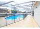 Fenced backyard with a screened-in pool and outdoor living space at 10001 Newington Dr, Orlando, FL 32836
