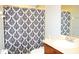 Bathroom with patterned shower curtain and single sink at 1028 Merrimack Blvd, Davenport, FL 33837