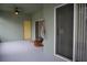Covered patio with sliding glass doors and yellow door at 1028 Merrimack Blvd, Davenport, FL 33837
