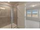 Modern bathroom with a walk-in shower and tile flooring at 10425 Folly Beach Rd, Orlando, FL 32827