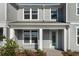 Two-story home with gray siding, light green door, and small porch at 10425 Folly Beach Rd, Orlando, FL 32827