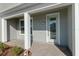 Inviting front porch with light green door and brick walkway at 10425 Folly Beach Rd, Orlando, FL 32827