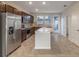Modern kitchen with island and stainless steel appliances at 10425 Folly Beach Rd, Orlando, FL 32827
