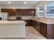 Modern kitchen with island, stainless steel appliances, and dark wood cabinets at 10425 Folly Beach Rd, Orlando, FL 32827