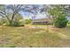 Spacious backyard with mature trees and grassy lawn at 109 Arrowhead Ln, Haines City, FL 33844