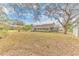 Spacious backyard with large trees and grassy area at 109 Arrowhead Ln, Haines City, FL 33844
