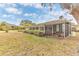 Spacious backyard with screened porch and grassy area at 109 Arrowhead Ln, Haines City, FL 33844