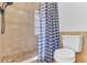 Bathroom with shower, toilet and blue checkered shower curtain at 109 Arrowhead Ln, Haines City, FL 33844