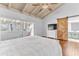 Main bedroom with wood floors, barn door, and access to bathroom at 109 Arrowhead Ln, Haines City, FL 33844