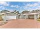House exterior showcasing a light green color scheme and a two-car garage at 109 Arrowhead Ln, Haines City, FL 33844