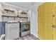 Laundry room with washer, dryer and yellow door at 109 Arrowhead Ln, Haines City, FL 33844