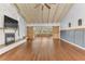 Bright living room featuring hardwood floors, a fireplace, and barn doors at 109 Arrowhead Ln, Haines City, FL 33844