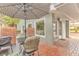 Relaxing patio with brick flooring, umbrella, and seating at 109 Arrowhead Ln, Haines City, FL 33844