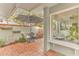 Charming brick patio with seating area and view of kitchen at 109 Arrowhead Ln, Haines City, FL 33844