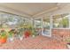 Spacious screened porch with brick flooring and lush plants at 109 Arrowhead Ln, Haines City, FL 33844
