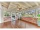 Relaxing sunroom with wood floors, brick walls, and access to backyard at 109 Arrowhead Ln, Haines City, FL 33844