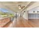 Spacious sunroom with wood floors, brick feature wall, and home gym at 109 Arrowhead Ln, Haines City, FL 33844