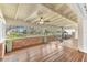 Bright sunroom features wood floors, brick walls, and plenty of natural light at 109 Arrowhead Ln, Haines City, FL 33844